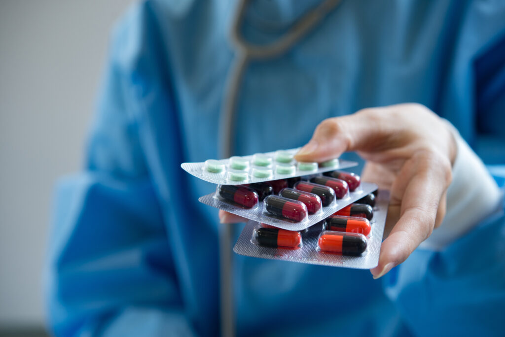 woman pharmacist holding prescription medicine from doctor order